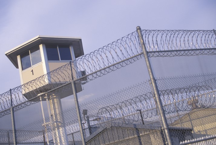 Prison guard station behind fence. 